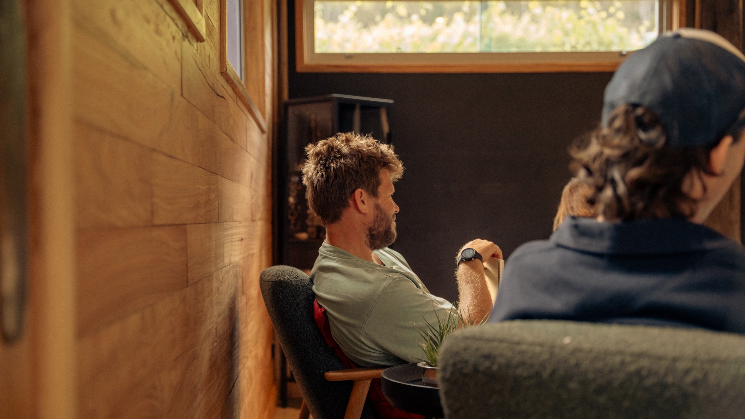 Two participants seen through the cellar door window